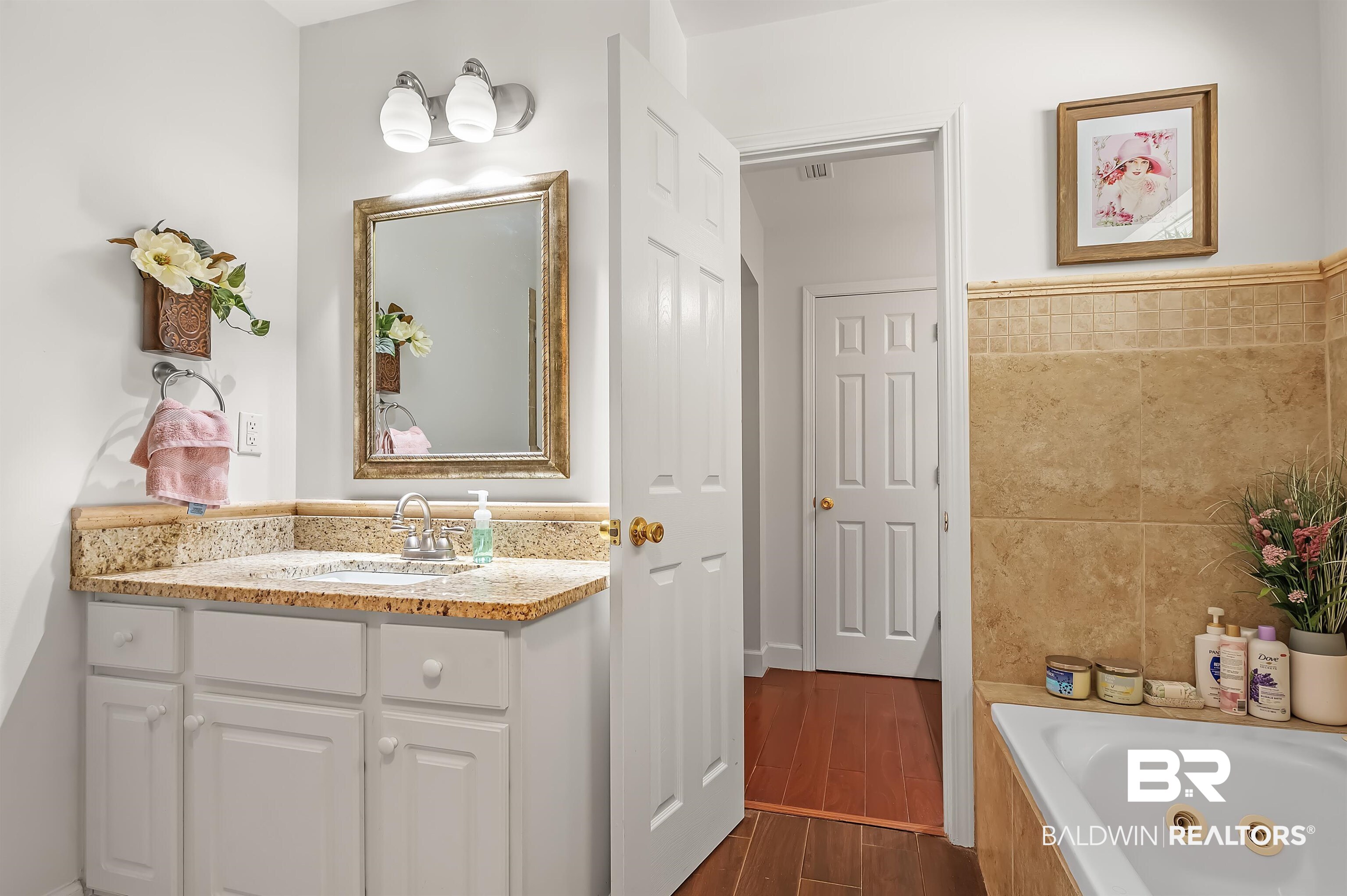 9901 Glover Court Fairhope, AL 36532 - Photo 22 of 52 Bathroom with tile walls, hardwood / wood-style floors, vanity, and a bathing tub