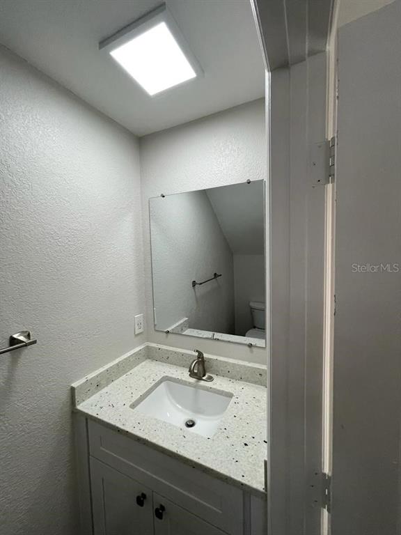 10260 Turkey Lake Road, Unit 150 (A30) Orlando, FL 32819 - Photo 11 of 13 a bathroom with a sink and a mirror