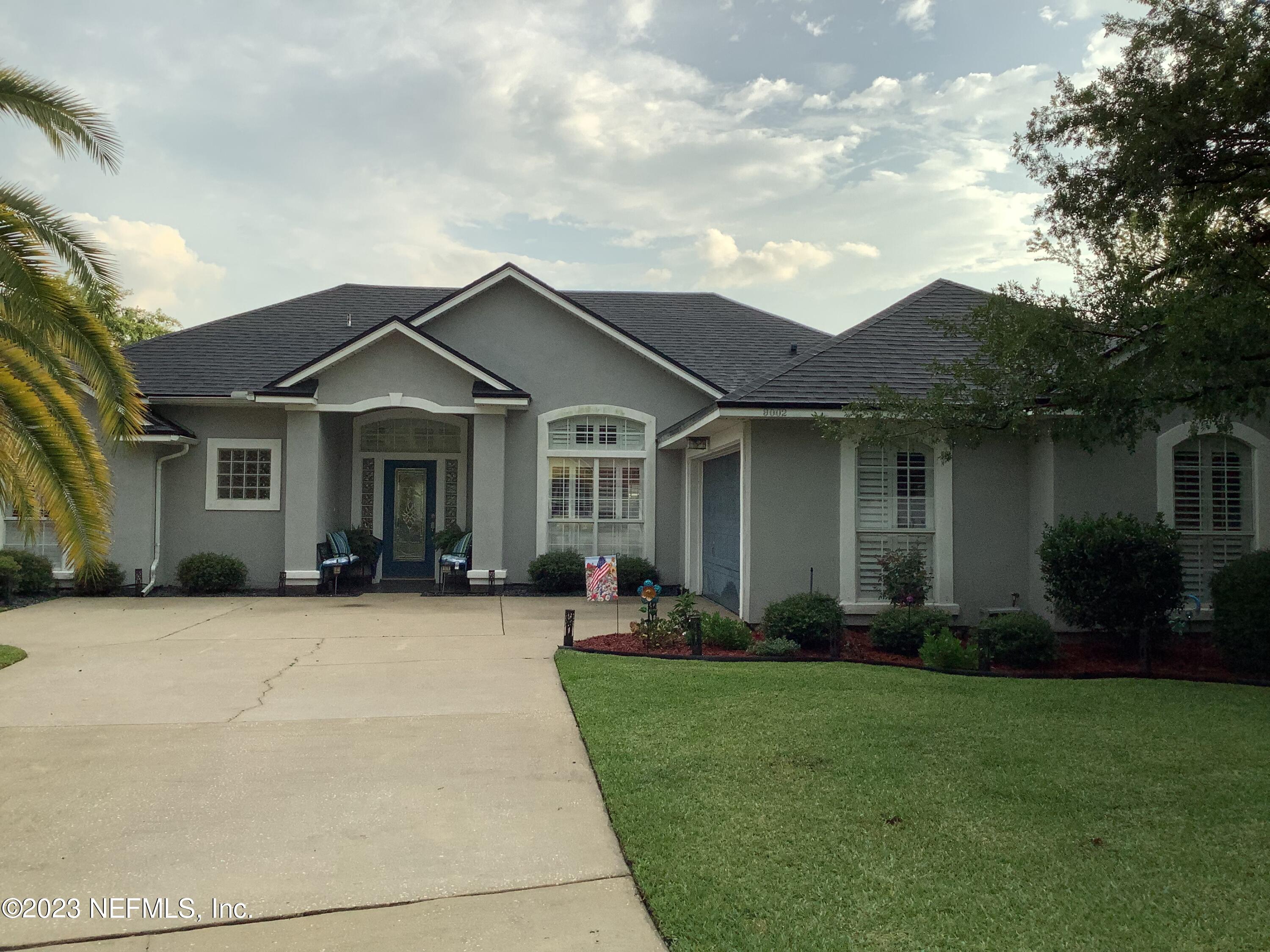 9002 Needlepoint Place Jacksonville, FL 32244 - Photo 1 of 1 a front view of a house with a garden and plants