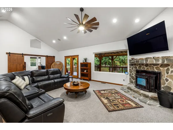 a living room with furniture a flat screen tv and a fireplace