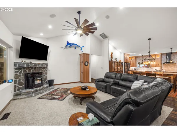 a living room with furniture a fireplace and a flat screen tv