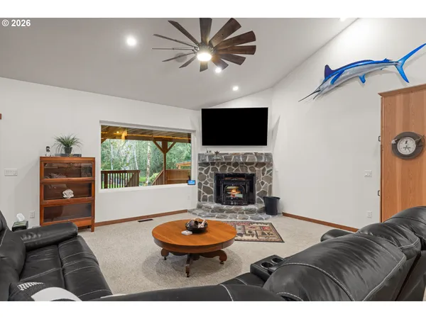 a living room with furniture a fireplace and a flat screen tv