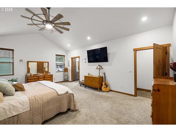a bedroom with furniture and a flat screen tv