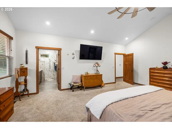 a bedroom with a bed and a flat screen tv