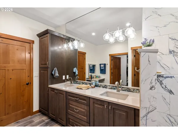 a bathroom with a sink mirror and a shower