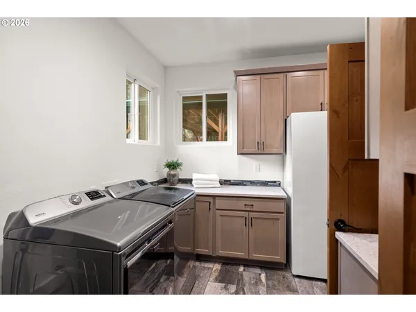 a kitchen with a sink refrigerator and cabinets