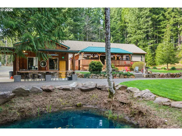 a view of a house with backyard sitting area and garden