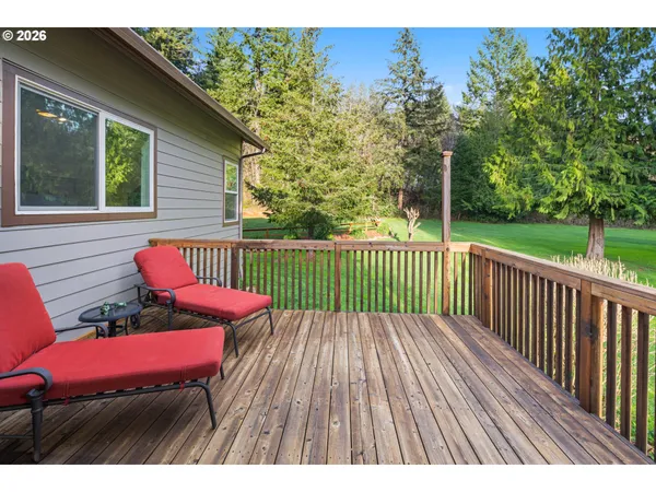 a view of balcony with wooden floor and outdoor seating
