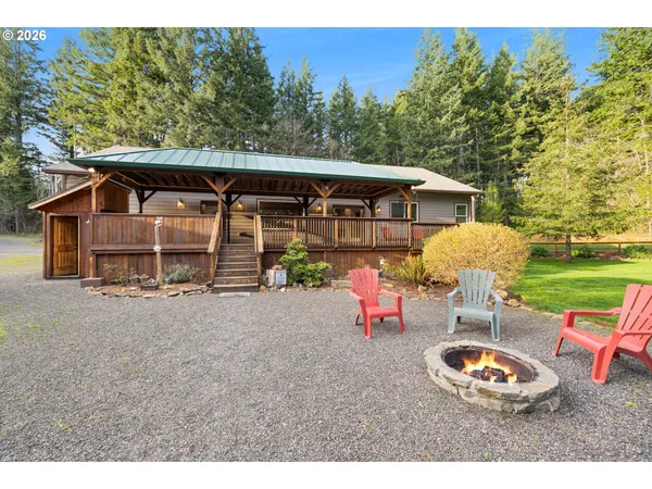 a backyard of a house with barbeque oven table and chairs