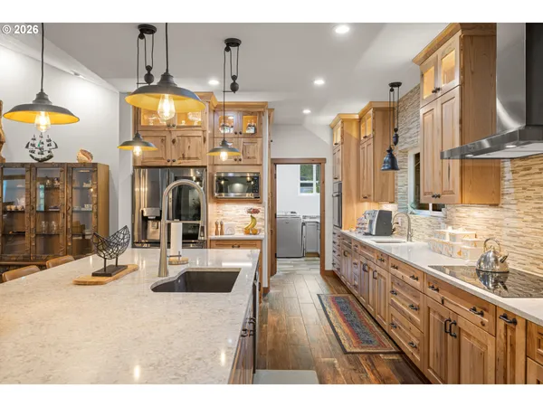 a kitchen with stainless steel appliances kitchen island granite countertop a sink and cabinets