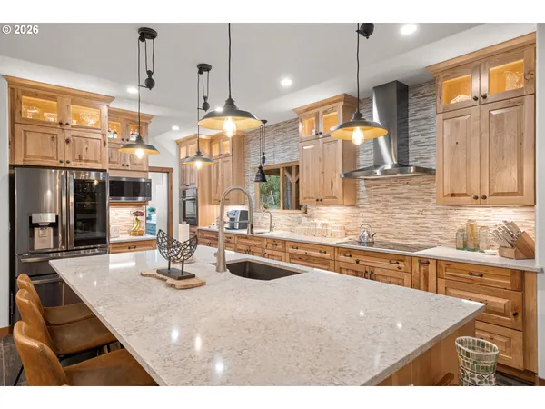 a kitchen with kitchen island granite countertop a sink cabinets and window