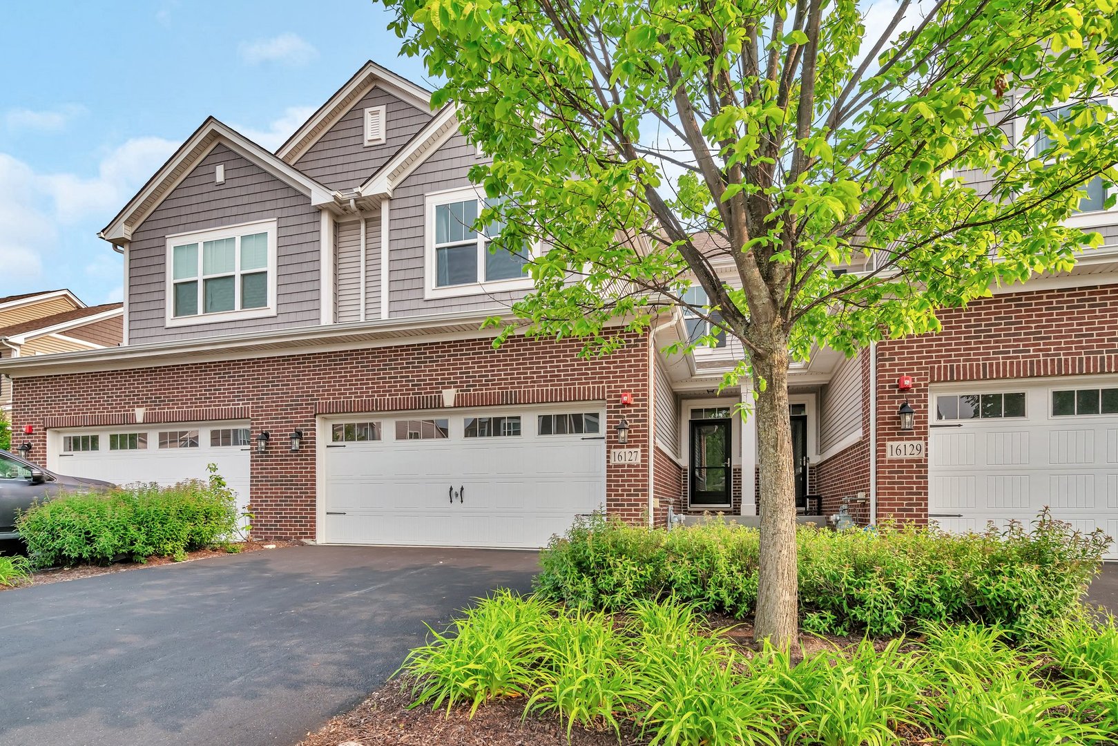 16127 West Switch Grass Road Lockport, IL 60441 - Photo 1 of 19 a front view of a house with a yard and garage