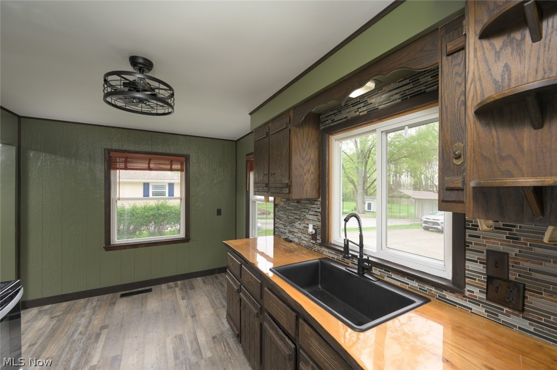 1603 Grandview Road Lake Milton, OH 44429 - Photo 21 of 35 Eat in area with large windows. Live edge countertop and farm sink.