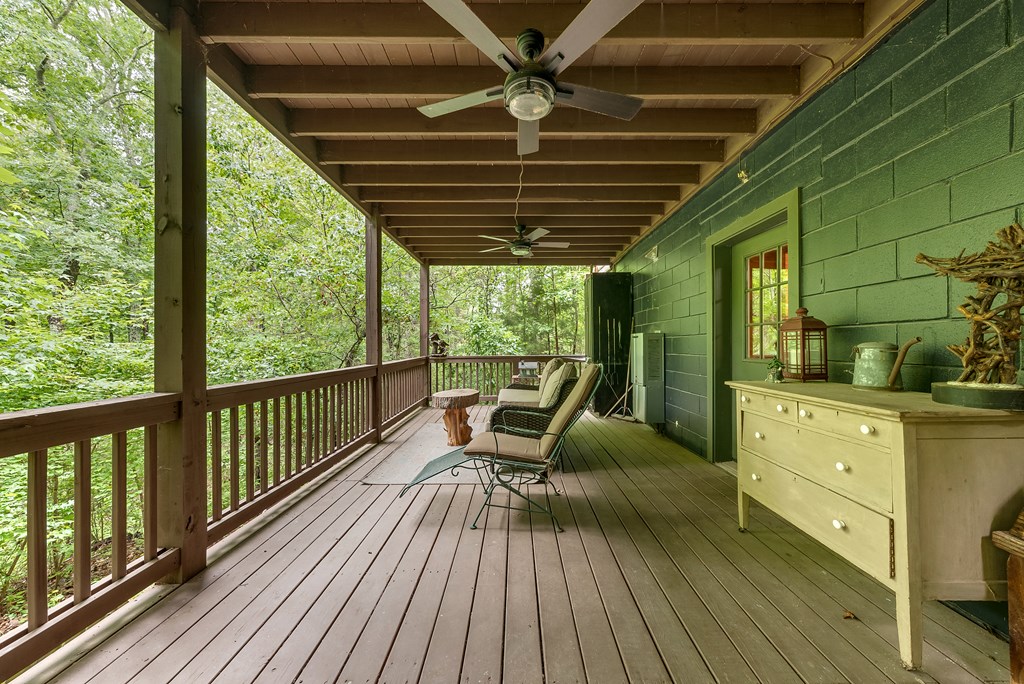 149 Mountain Springs Road Warm Springs, GA 31830 - Photo 38 of 43 a view of a balcony with chairs and wooden floor