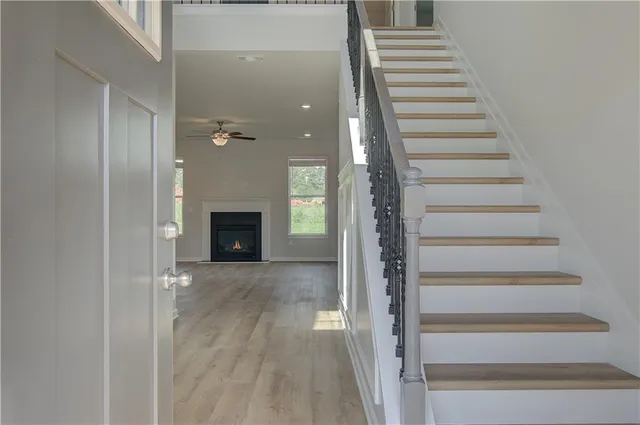 a view of a hallway with wooden floor and entryway