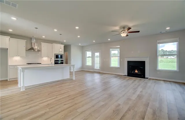 a view of kitchen with refrigerator and microwave
