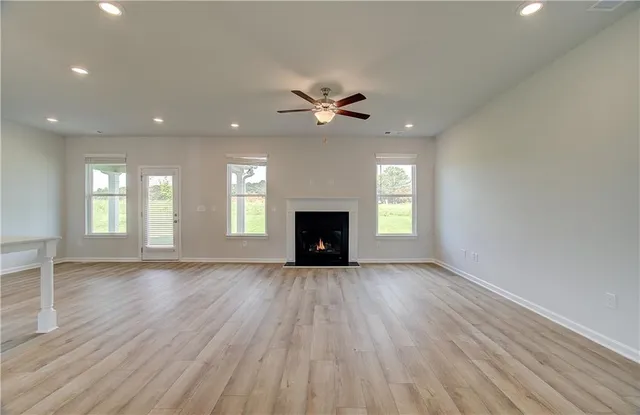 an empty room with fan and windows