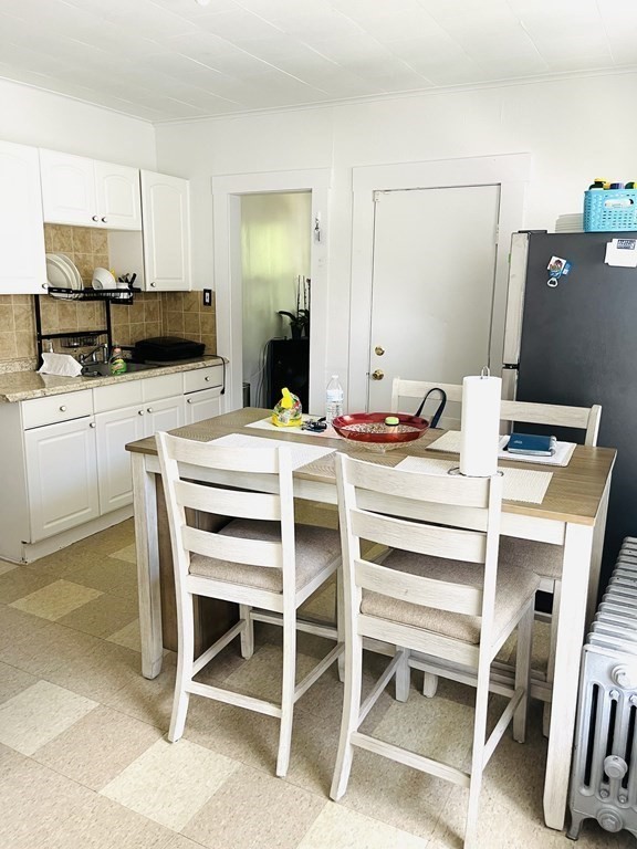 49 Bryant Street Springfield, MA 01108 - Photo 33 of 40 a kitchen with a stove a table and chairs in it