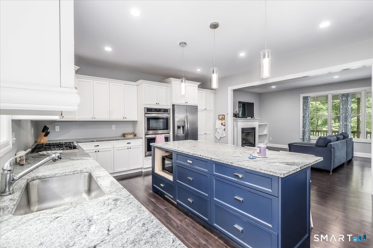 127 Putnam Park Road Bethel, CT 06801 - Photo 2 of 35 a kitchen with a stove a sink and a refrigerator