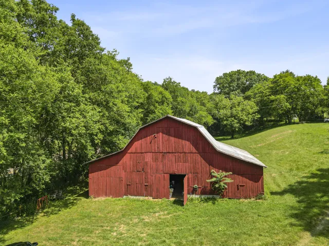 a view of yard with swimming pool and trees