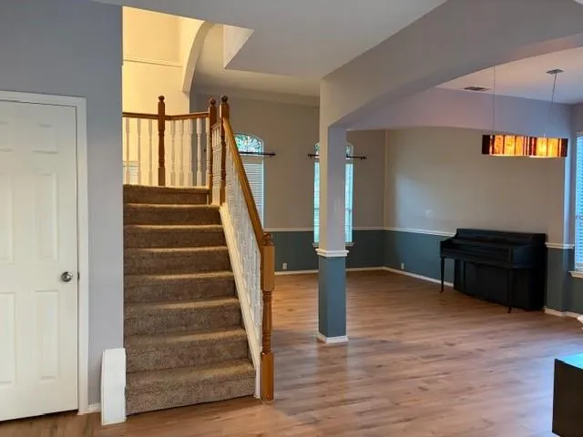 a view of entryway and hall with wooden floor