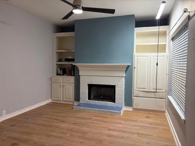 a view of a livingroom with a fireplace and wooden floor