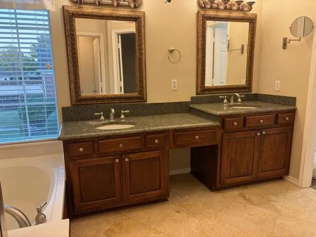 a view of a backyard with large trees and wooden fence