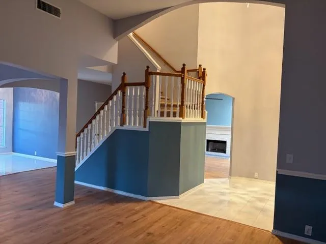 a view of entryway and hall with wooden floor