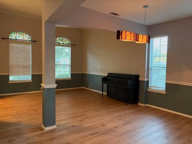 a living room with hard wood floors and a window