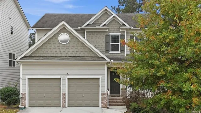 a front view of a house with a yard