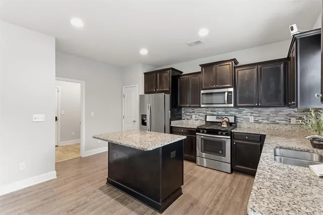 a bathroom with a sink double vanity granite tub shower and a mirror