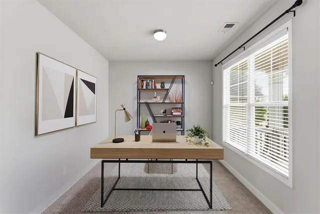 a view of a livingroom with a fireplace and a ceiling fan