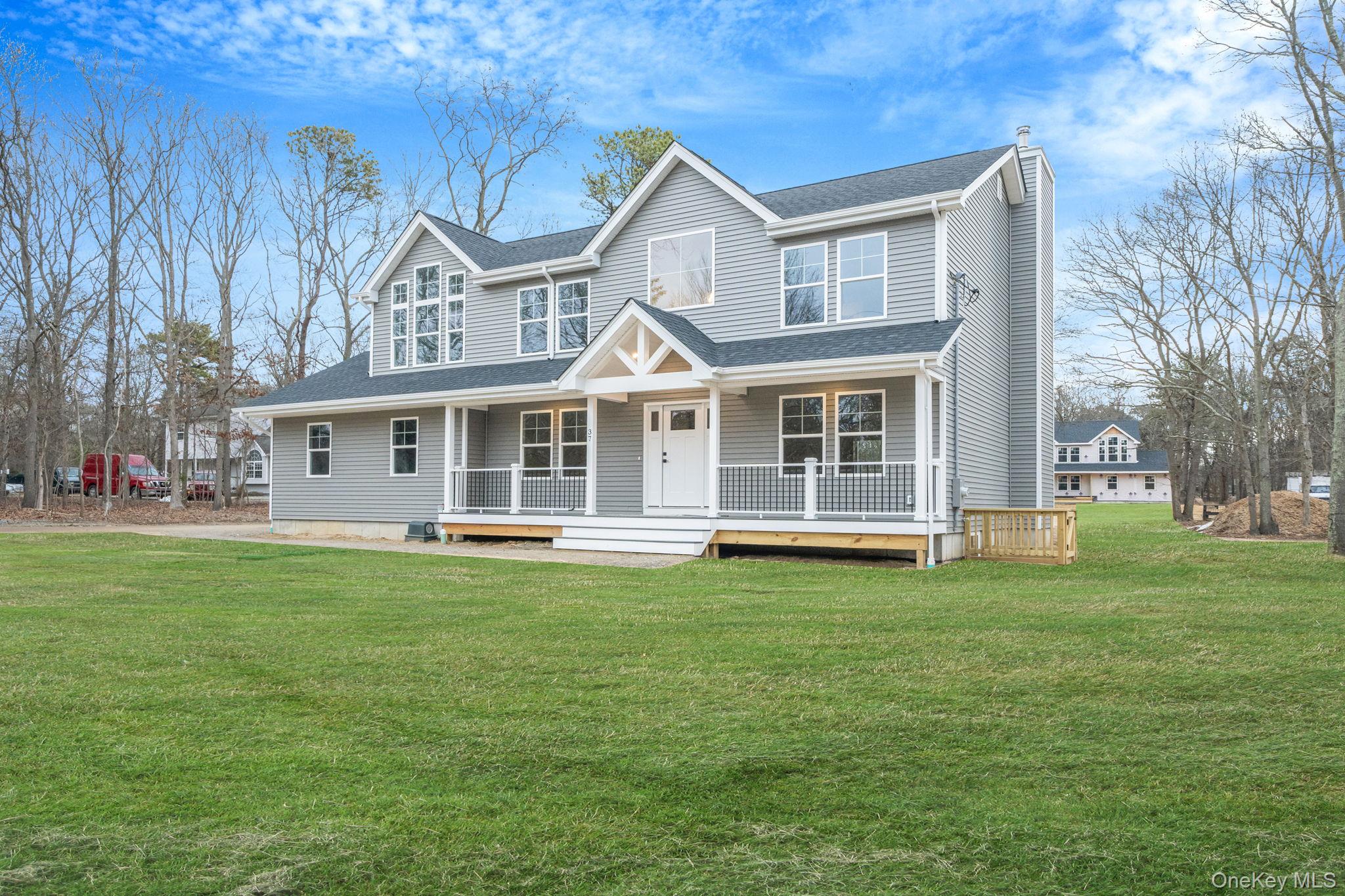 63 B Blydenburgh Road Centereach, NY 11720 - Photo 2 of 38 a front view of a house with a garden