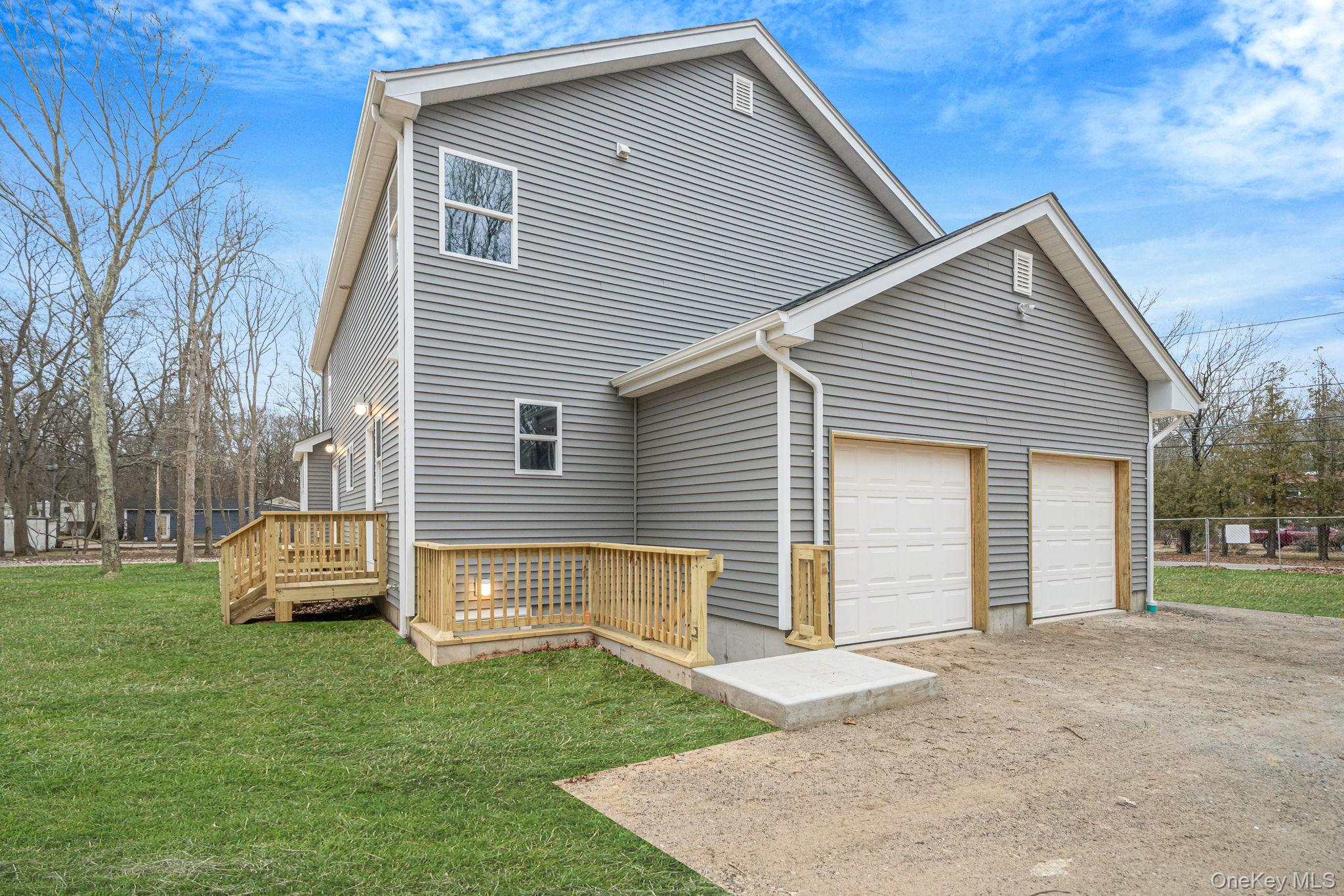 63 B Blydenburgh Road Centereach, NY 11720 - Photo 33 of 38 a front view of a house with a garden and yard