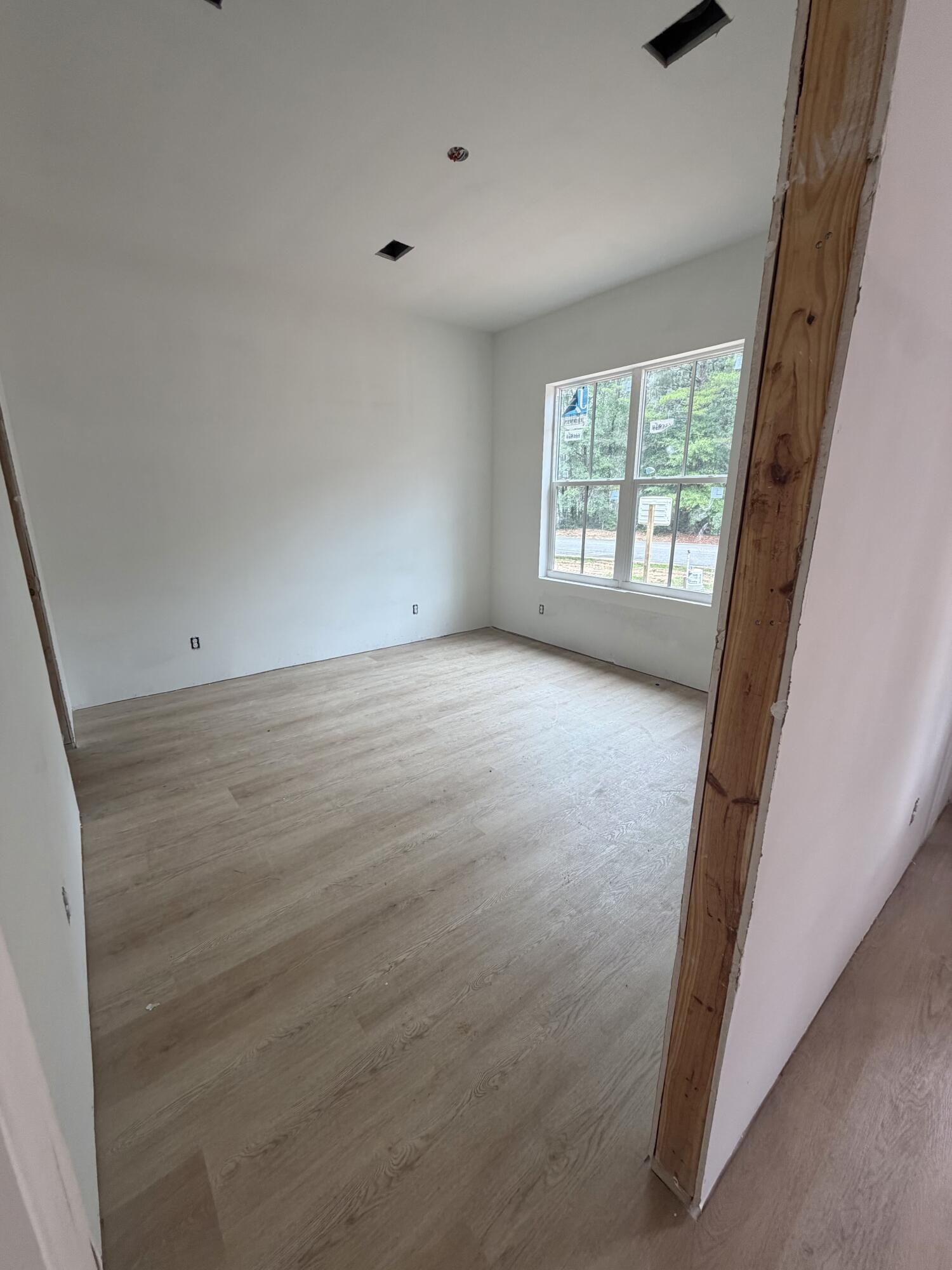 219 South J Hunter's Way, Unit LOT 73 Freeport, FL 32439 - Photo 9 of 10 an empty room with windows