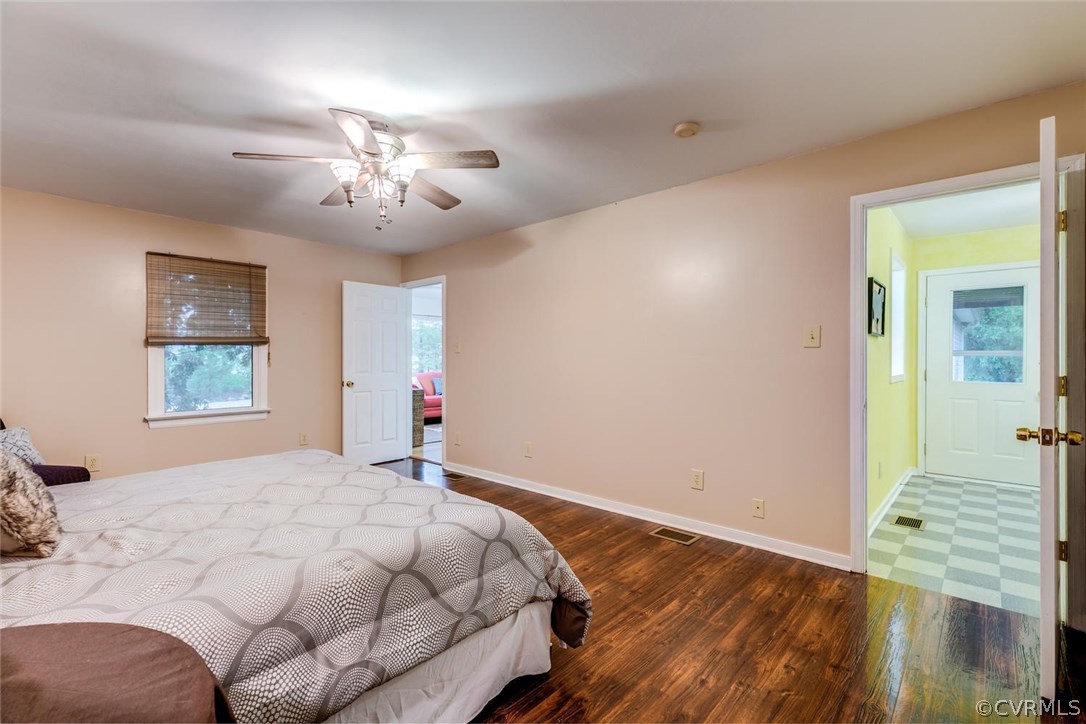 7413 River Road Hanover, VA 23069 - Photo 12 of 30 a bedroom with a bed and a chandelier