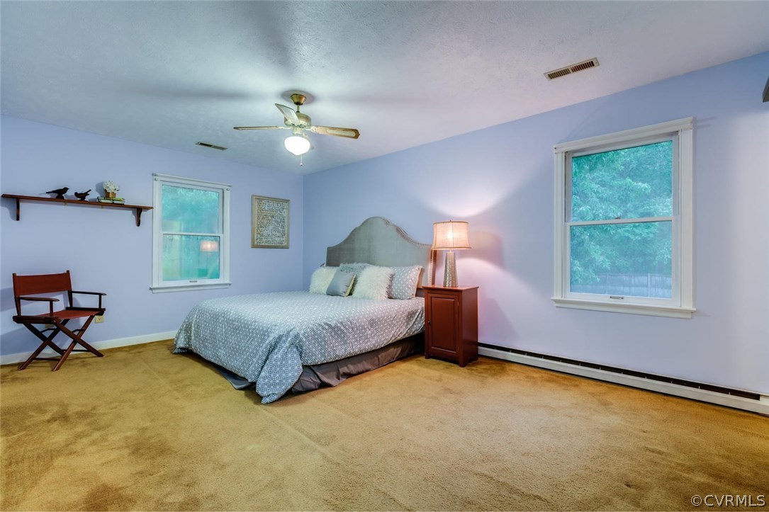 7413 River Road Hanover, VA 23069 - Photo 16 of 30 a bedroom with a bed window and a table