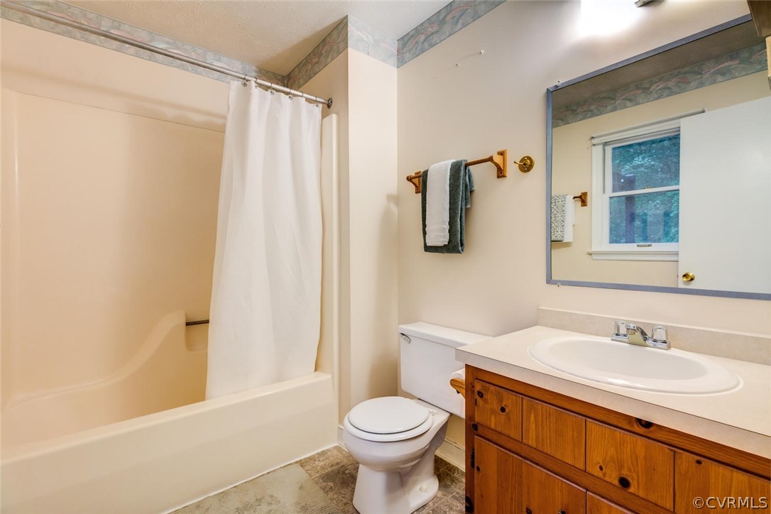 7413 River Road Hanover, VA 23069 - Photo 18 of 30 a bathroom with a sink toilet and shower