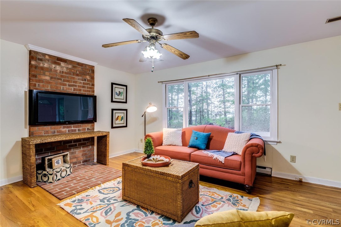 7413 River Road Hanover, VA 23069 - Photo 2 of 30 a living room with furniture a flat screen tv and a fireplace