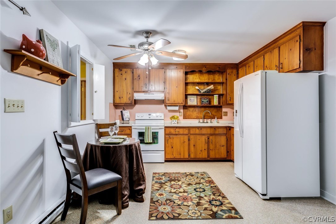 7413 River Road Hanover, VA 23069 - Photo 8 of 30 a kitchen with stainless steel appliances granite countertop a dining table and chairs