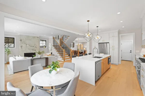 a kitchen with a dining table chairs and refrigerator