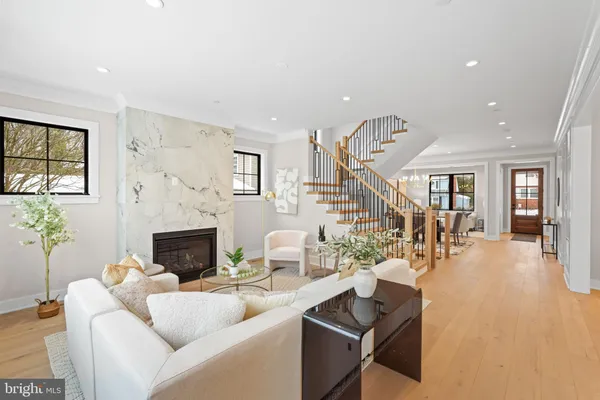 a large white kitchen with a large window and stainless steel appliances