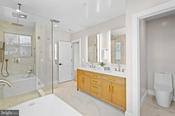 a spacious bathroom with a double vanity sink a mirror and shower
