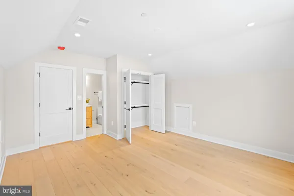 an empty room with windows and closet