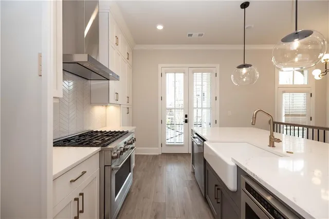 a kitchen with stainless steel appliances a sink stove and refrigerator