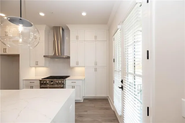 a kitchen with stainless steel appliances granite countertop a refrigerator a sink and a stove