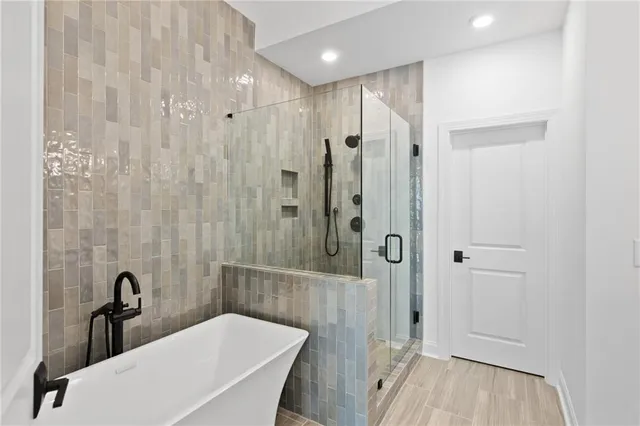 a bathroom with a sink a toilet a tub and shower