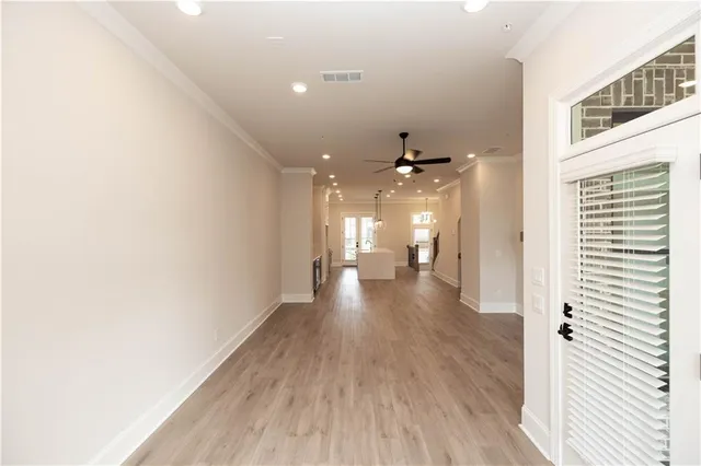 a view of a hallway with wooden floor