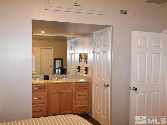 a bathroom with a sink a large mirror and a shower