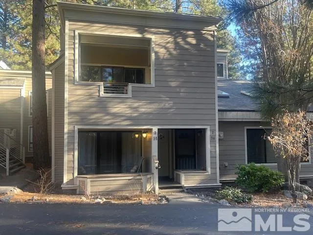 a view of brick house with large windows